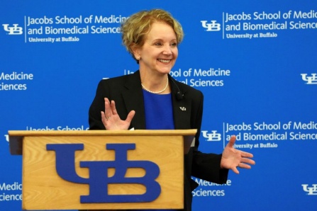 Allison Brashear, MD, MBA standing at a podium. 