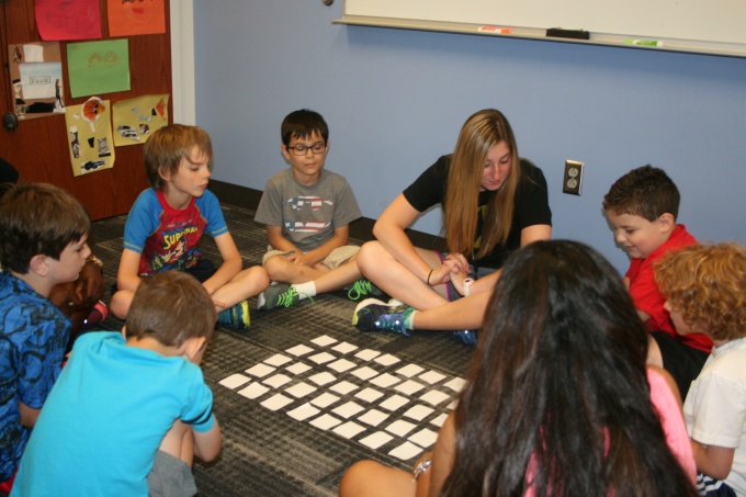 Children participate in a game with their teacher. 