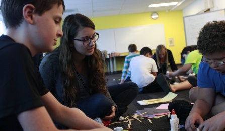 IAR students working on crafts with their teacher. 