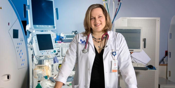 Dr. Watt is in a clinical setting. 