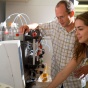 Photo of Mark Sutton and student at work in his lab. 