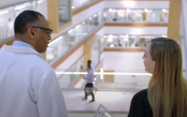 Dr. Milling walking down the stairs at the Jacobs School. 
