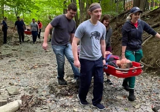 Emergency medical residents practice carrying someone out in a stretcher.
