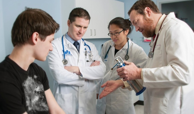 Faculty, residents and a patient. 