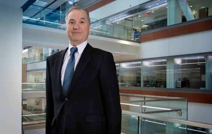 Dr. Russo stands in the Jacobs School. 