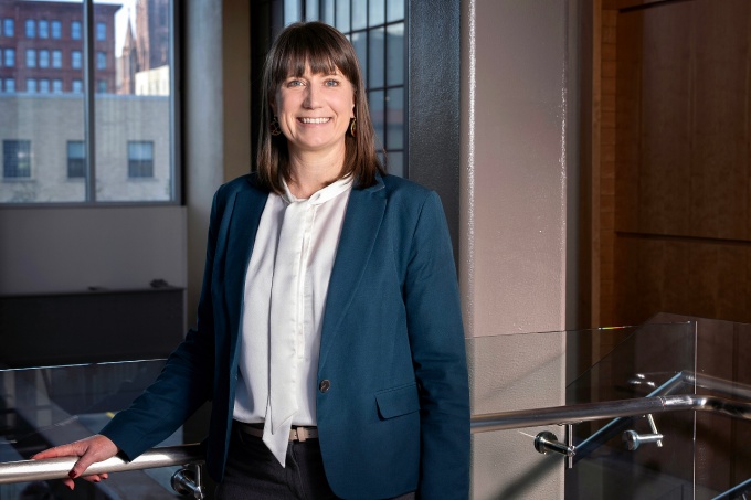 Rebekah J. Walker, PhD, stands near a window.