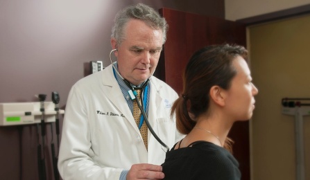 William J. Gibbons, MD, with a patient.