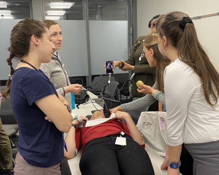 Residents performing point of care ultrasound during a med-peds didactic session. 