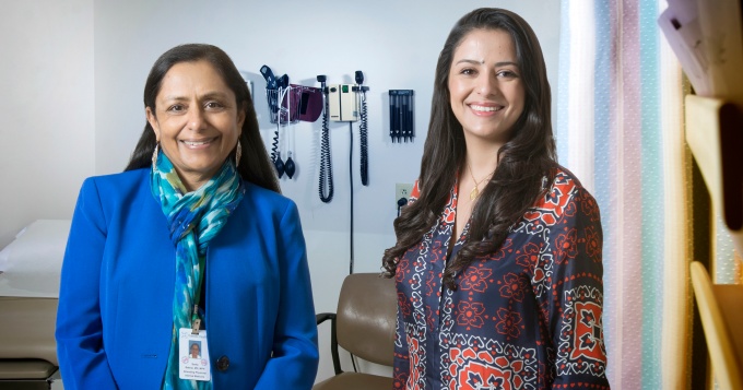 Program director, Smita Bakhai, stands with Einas Batarseh, a resident, within a clinical setting. 