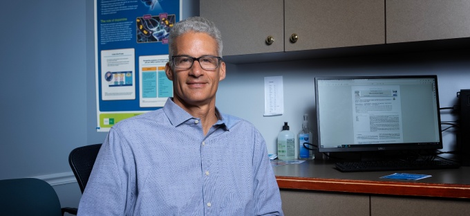 Dr. Guttuso sits in a clinical setting. 