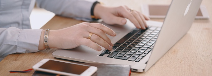 A physician stands in a clinical setting.