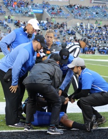 Medical staff with injured football player. 