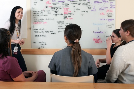 Susana Ruano, MD, pediatric residency faculty advisor, pediatric emergency medicine physician with a group of PGY1 residents.