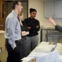 Pharmaceutical representative talking with a group of faculty and residents. 