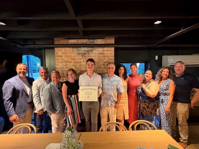 2024-2025 Fellow, Tyler Collins with program faculty at the 2025 fellowship graduation dinner. 