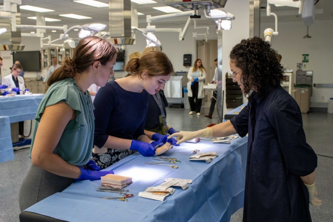 Alison Pletch, MD, leading a suturing lab with surgery residents. 