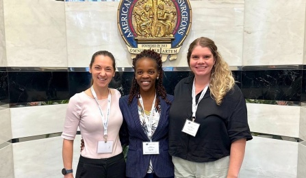 Three surgical residents at a conference. 