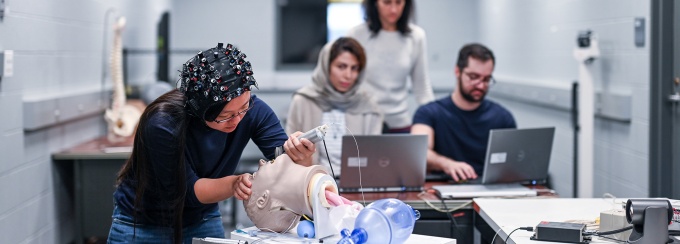 SURGE Lab members and Dr. Cavuoto conducting a study on intubation using the NIRS cap. 