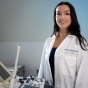 Daniela Hinchman-Dominguez, MD, standing near an ultrasound station. 