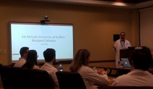 Zoom image: Dr. Mike Ernst presents his argument at the Resident Debate. 