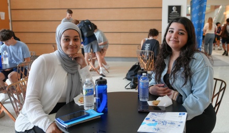 Students sitting at a table during an event.