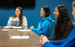 Students sitting around a table. 