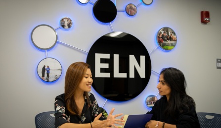 Students talking at a table in ELN space.