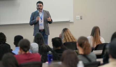 faculty member talking to students.