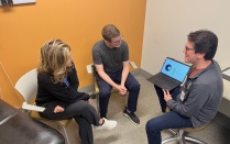 Two people meeting with a genetic counselor. 