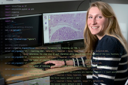 Student sitting by a computer in a research lab. 