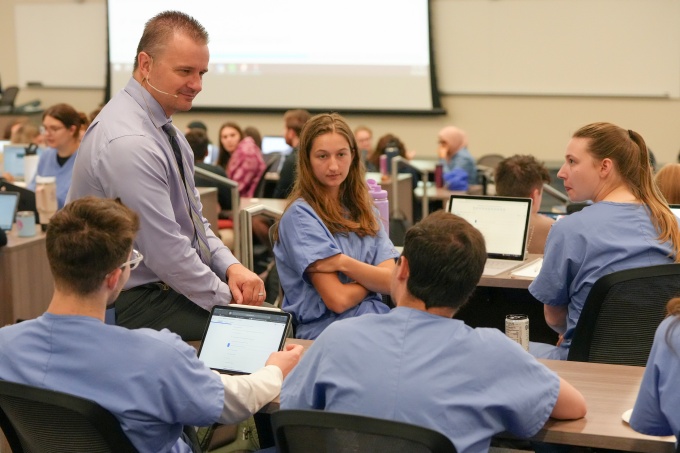 Students learn in a clasroom with a faculty member. 