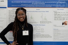 M3 student presenting a poster of their research at the research forum. 