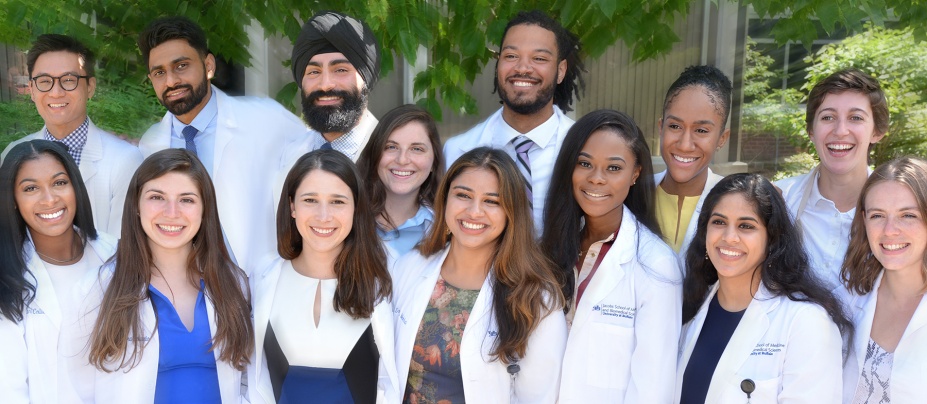 Group of medical students outside in their white coats. 