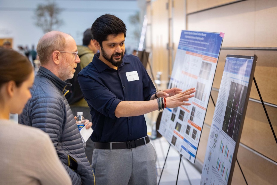 Student presenting a poster at Neuroscience research day.