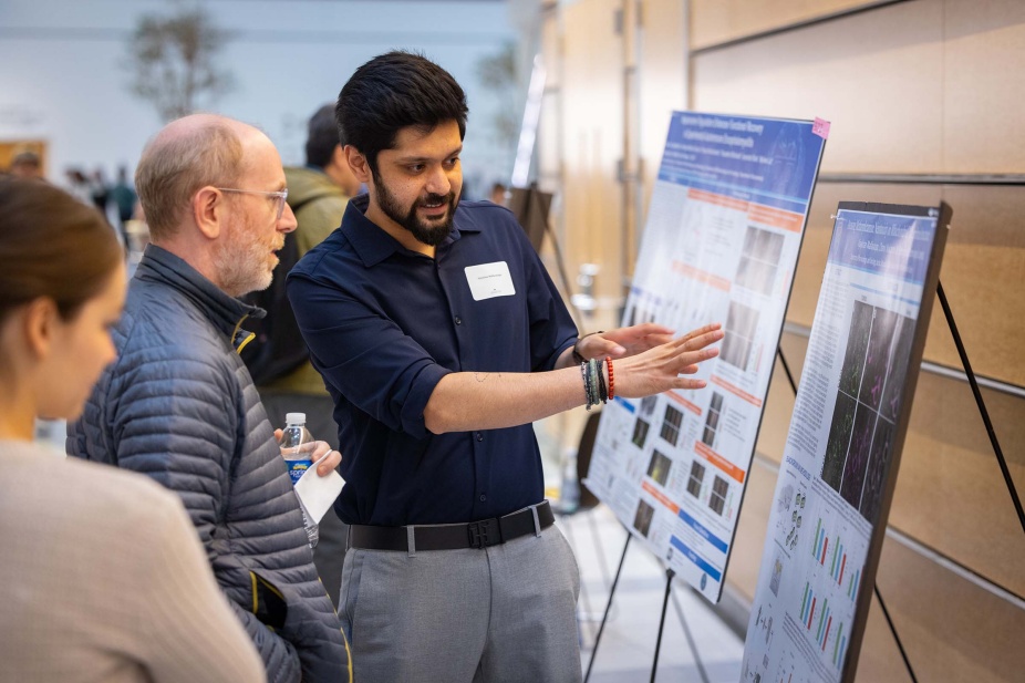 Student presenting a poster at Neuroscience research day. 