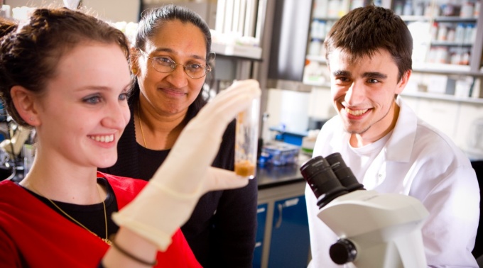 Biology faculty mentor Shermali Gunawardena and her mentees examine a sample in the lab. 