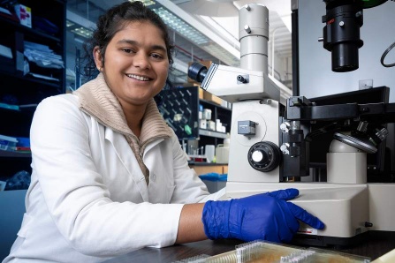 Student at microscope, Pallavi Phadtare. 