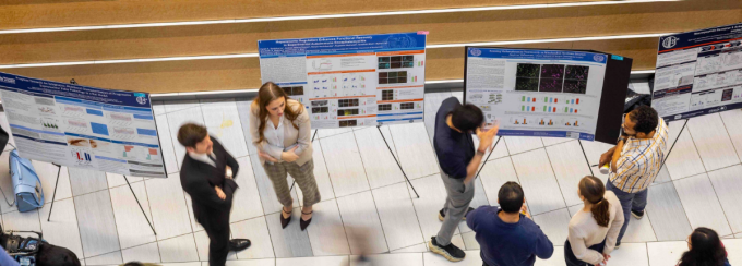 Students and faculty interacting at Neuroscience Research Day poster session. 