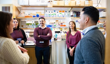 A group of students in a research lab. 