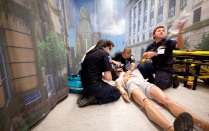 Three students simulate an emergency call. 