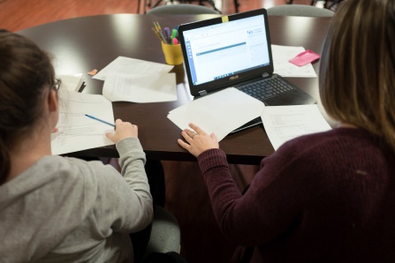 students working together at a computer. 