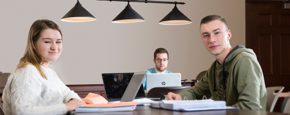 Students at table in tutoring center. 