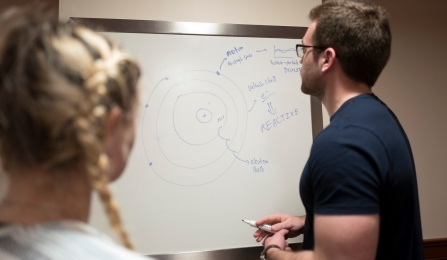 students at tutoring center working at whiteboard. 