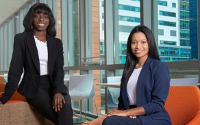 Two students dressed up in a common area.