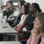 People listen to a talk at the Remembrance Conference. 