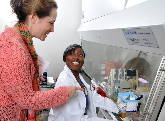 Two people interacting in a lab. 