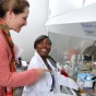 Two people interacting in a lab. 