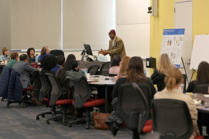 Male teaching in front of class. 