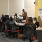 Male teaching in front of class. 