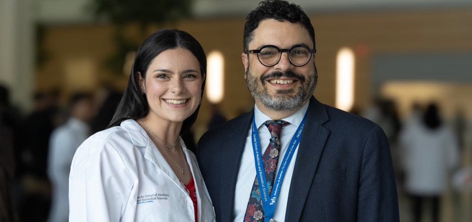 Dr. John Panepinto standing beside a PhD student. 